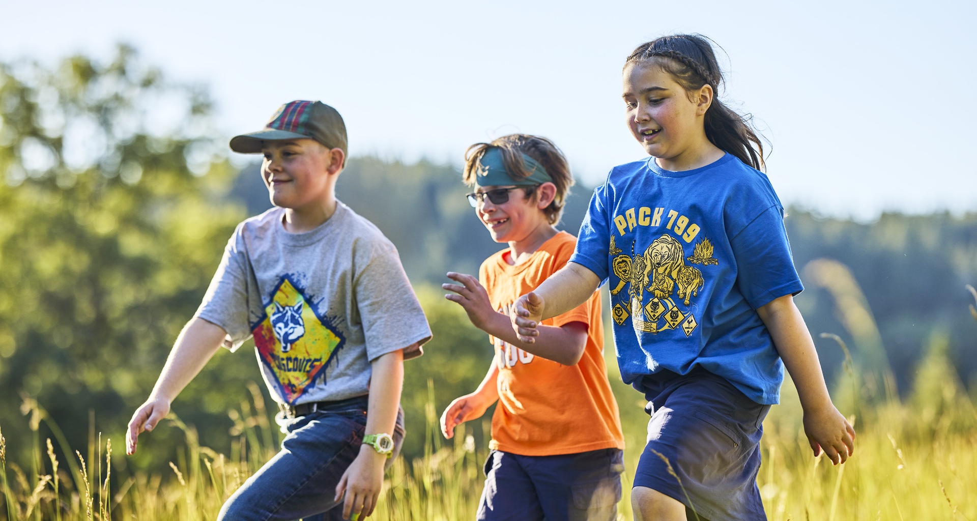 Three Cub Scouts hiking outdoors